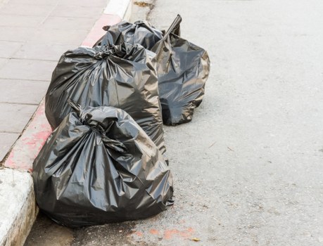 Workers loading a skip at an eco-friendly depot