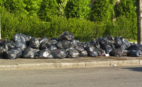 Staff assessing skip contents for safety before collection