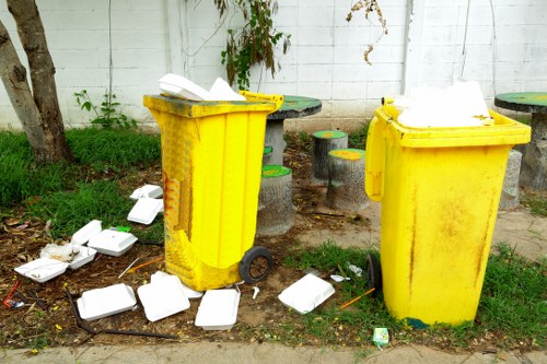 Different types of construction waste loaded into a skip